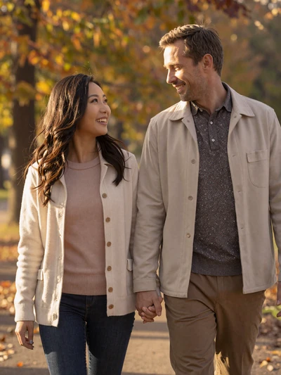 Happy couple walking in an autumn park after meeting on MagnoliaDate Asian dating platform